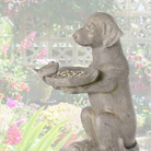 The resin dog bird feeder placed in a floral garden setting, creating a cozy and inviting outdoor aesthetic.