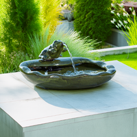 A beautifully staged garden scene with the fountain gently cascading water, blending seamlessly into outdoor decor.