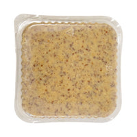 Vacuum-sealed plastic pouch of grainy mustard with speckled brown seeds visible through clear packaging. The mustard's texture appears thick and coarse.