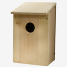 Prime Retreat cedar bird shelter mounted outdoors, ideal for screech owls, saw-whet owls, and kestrels, with natural wood design for nesting and weather resistance.