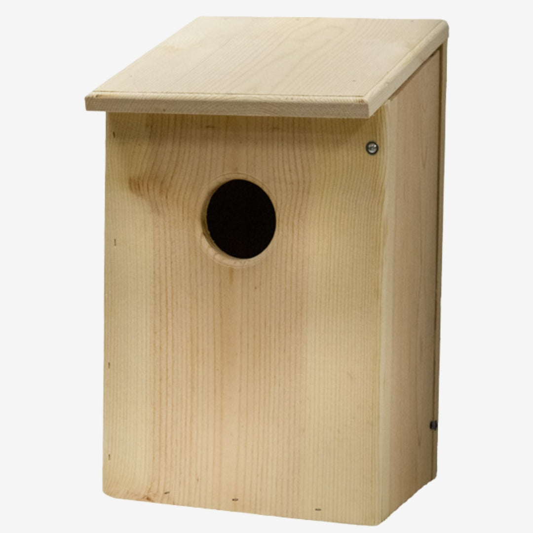Prime Retreat cedar bird shelter mounted outdoors, ideal for screech owls, saw-whet owls, and kestrels, with natural wood design for nesting and weather resistance.