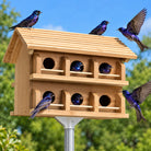 cedar purple martin house with 8 purple martins flying around