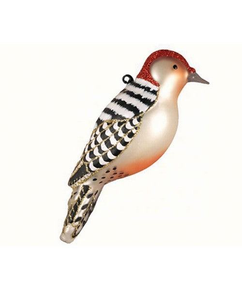 Glass ornament of a woodpecker on a white background