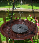 Hanging bird bath with water feature in a garden setting
