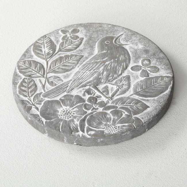 Songbird Stepping Stone featuring a carved bird and flowers in a gray cement finish, perfect for adding charm to gardens and outdoor spaces