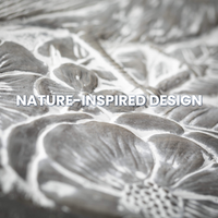 Close-up of Songbird Stepping Stone featuring intricate flower, leaf, and bird design in a gray cement finish, perfect for garden paths and outdoor decor