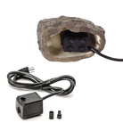 A close-up view of the electric pump hidden inside the Stonecreek Waterfall Rock, with a power cord visible.