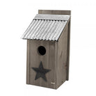 Wooden birdhouse with a star design on a white background