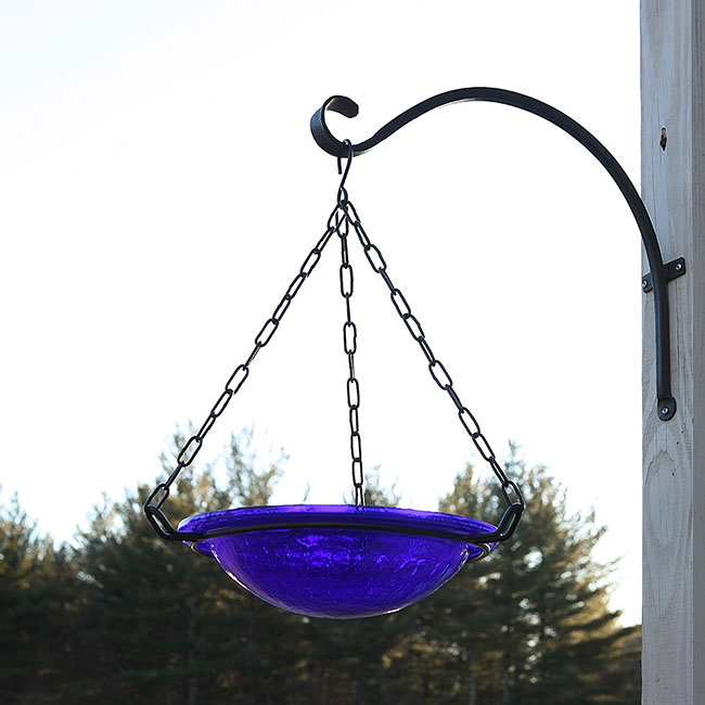 A close-up shot of the sturdy scroll wall hook with a powder-coated finish, installed on a post, showing its long-lasting design for outdoor use with heavy-duty support.