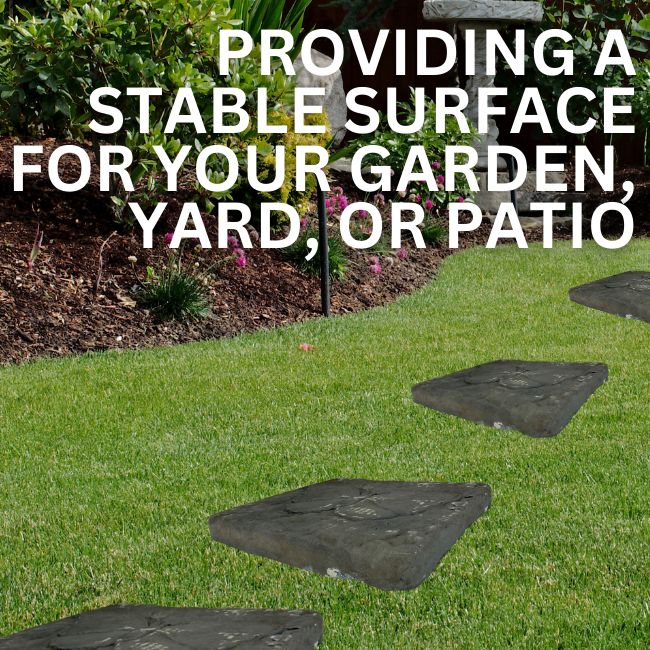 A set of two butterfly-shaped concrete garden stepping stones with delicate wing details and a natural gray finish, arranged on a garden path.