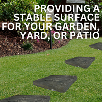 A set of two butterfly-shaped concrete garden stepping stones with delicate wing details and a natural gray finish, arranged on a garden path.