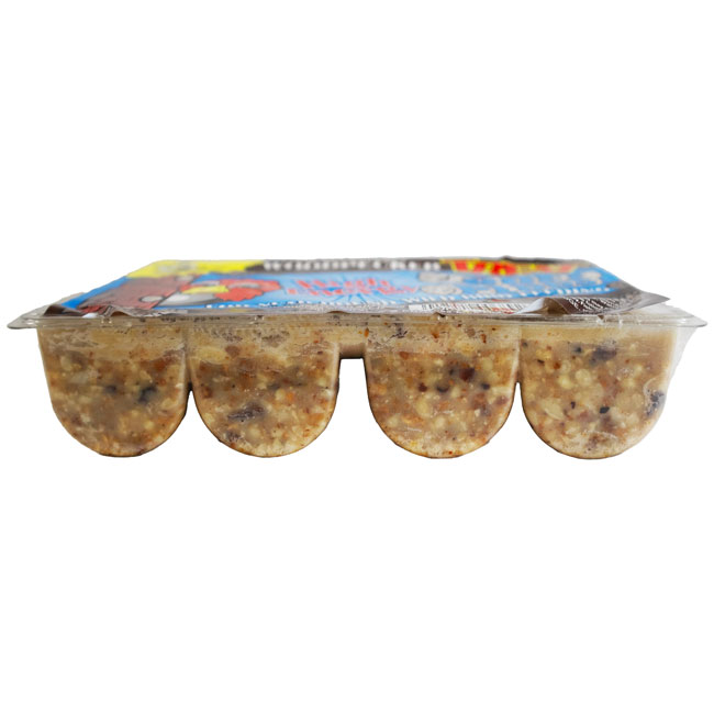 Pack of four bird seed cakes in clear plastic containers with colorful packaging on top. The cakes are light brown with visible seeds and grains.