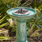 Close-up of the solar fountain insert's panel and 360-degree spray nozzle in direct sun.