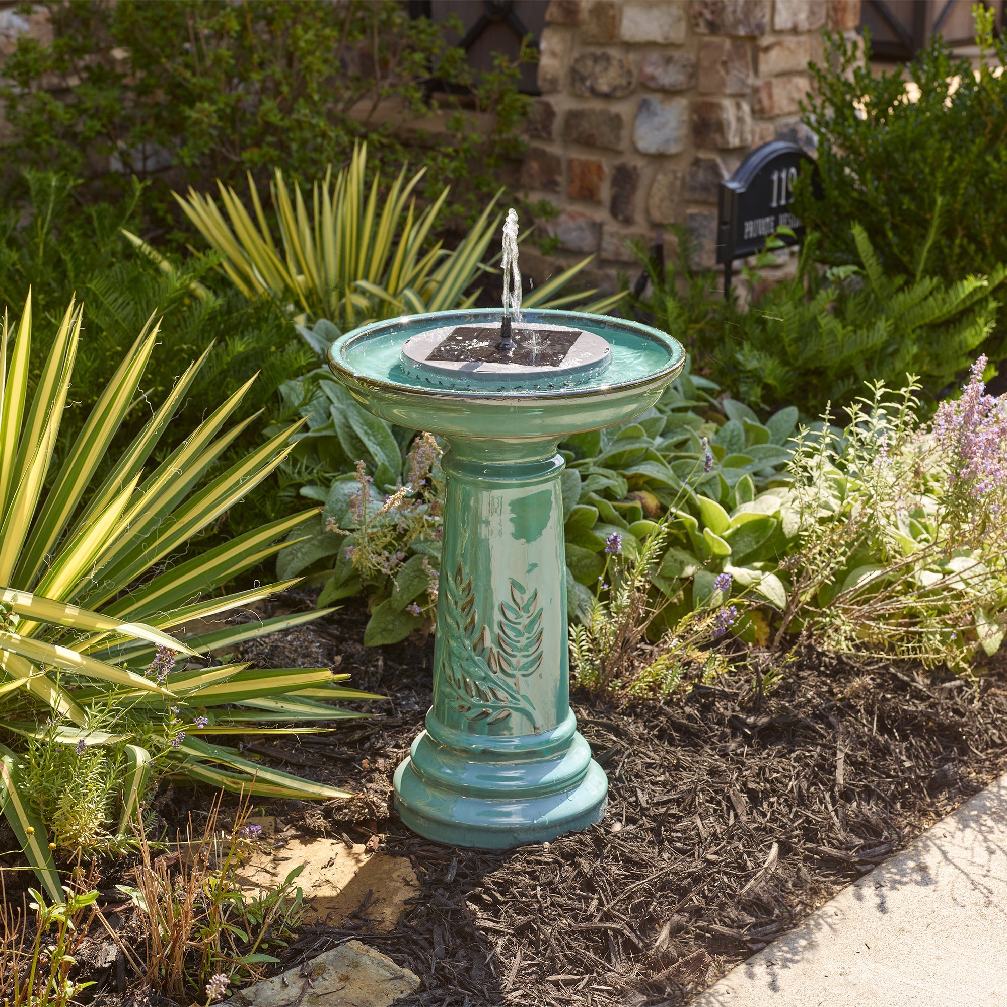 Solar fountain insert running the bubbler attachment in direct sunlight.