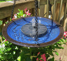 Solar panel blue ceramic birdbath with fountain and solar panel connected on a deck